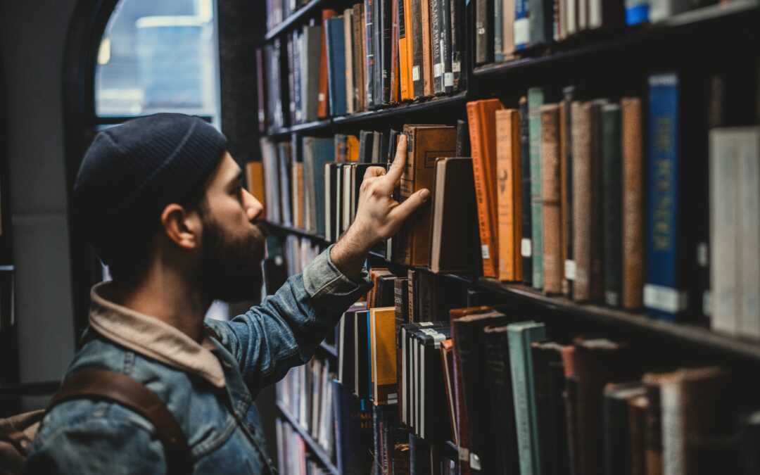 man-is-looking-at-the-books-in-the-library-book-recommendation